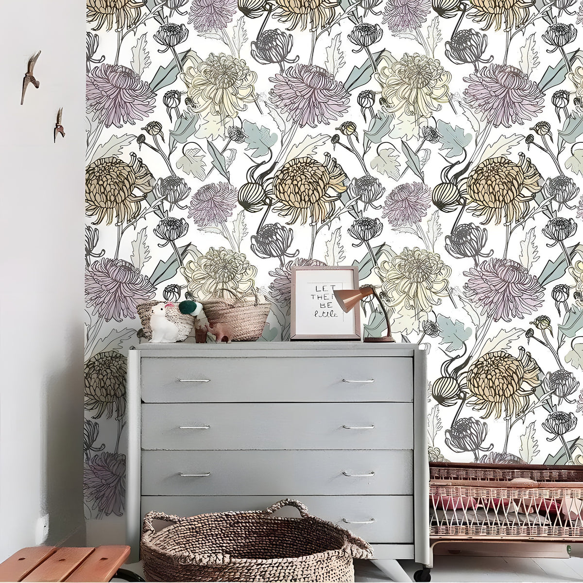 Colorful Spring Floral wallpaper on white ground, oversized purple and gold chrysanthemums, behind a gray dresser in nursery
