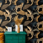 Cheetah and Ferns Dark Tropical wallpaper behind a teal dresser — gold cheetahs among slate and gold palm fronds on black