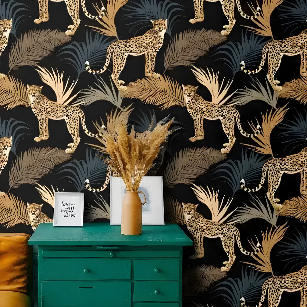 Cheetah and Ferns Dark Tropical wallpaper behind a teal dresser — gold cheetahs among slate and gold palm fronds on black