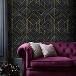 Faux gold and black art deco geometric wallpaper with diamond grid on dark marble behind plum velvet Chesterfield sofa