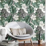 Retro zebra and monstera floral wallpaper in a living room with gray pod chair and wood coffee table