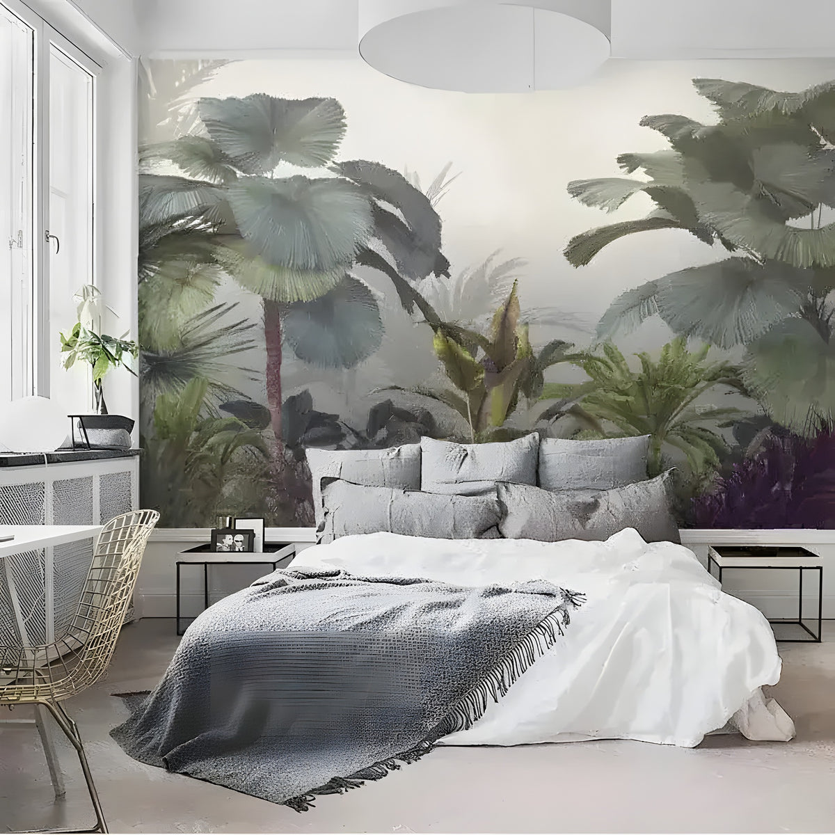 Misty tropical forest watercolor mural in bedroom with white bed, grey throw, gold wire chair and large window