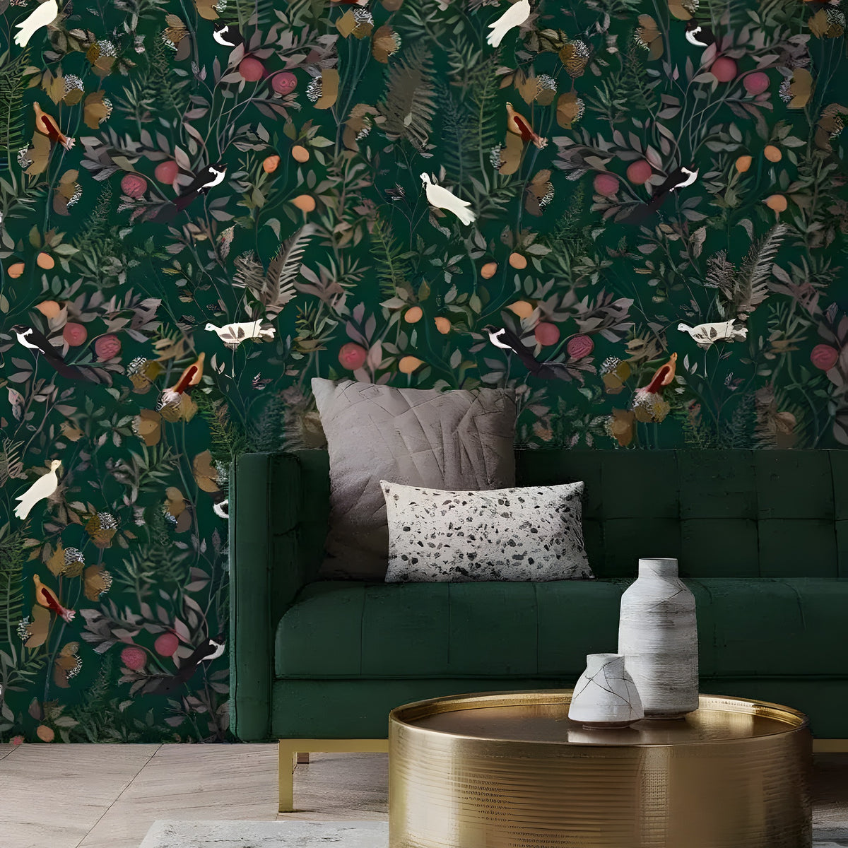 Green exotic birds watercolor wallpaper behind a deep green sofa with mauve cushions and a round gold coffee table