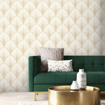 Pastel Art Deco fans wallpaper in cream and gold scallop pattern, styled in a living room with green sofa