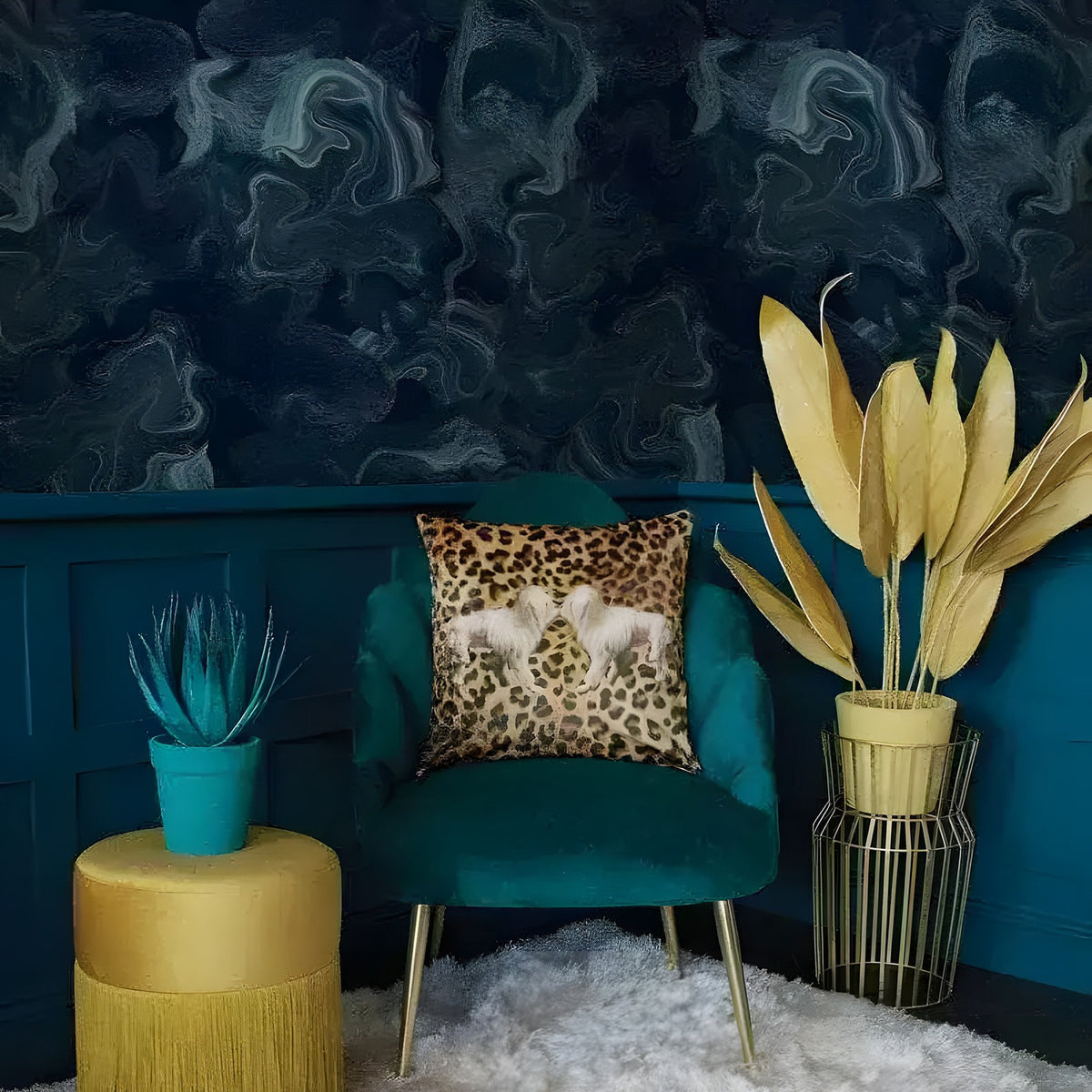 Dark blue abstract marble wallpaper mural with teal velvet chair, leopard cushion and gold fringe stool