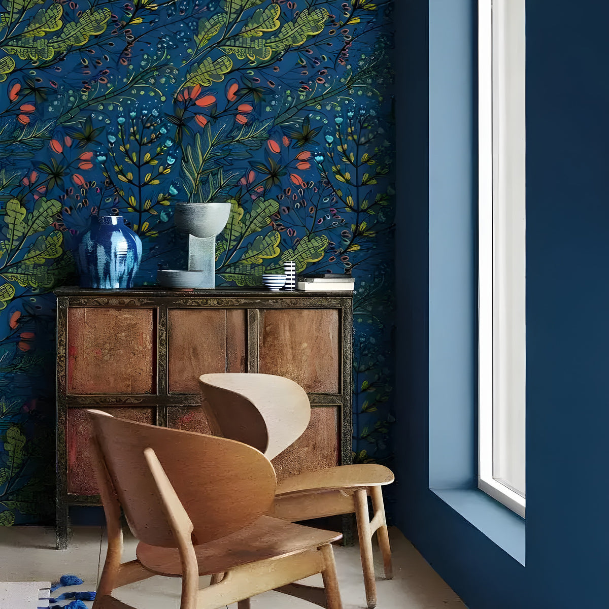 Dark blue watercolor botanical wallpaper with green leaves and coral berries in a Scandi corner with bentwood chair