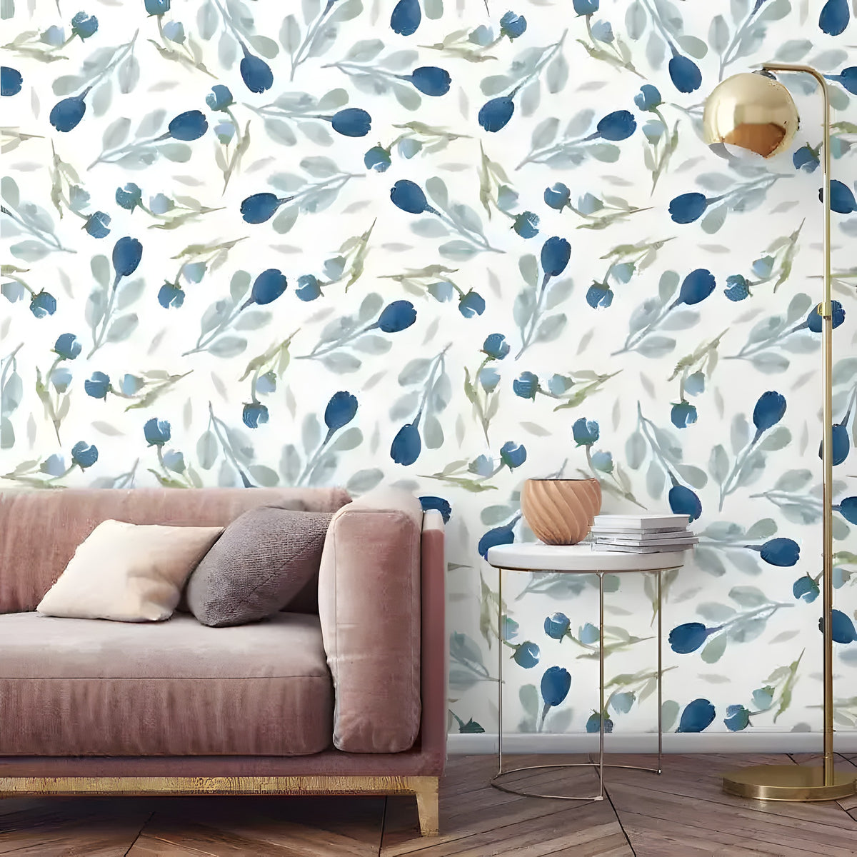 Minimalist blue floral wallpaper with ink-blue tulip buds on white behind a blush velvet sofa and gold ball floor lamp