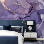 Dramatic Purple and Gold Abstract Marble mural above dark navy headboard, white lamp on gray nightstand