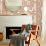 Dark tropical wallpaper with dense overlapping fern leaves in deep green on black, white console table and wooden ladder