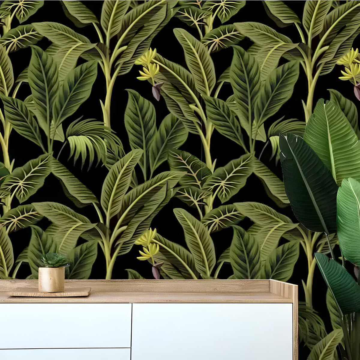Dark tropical banana and palm tree watercolor wallpaper with lush green leaves on black, above a white console and tropical plant