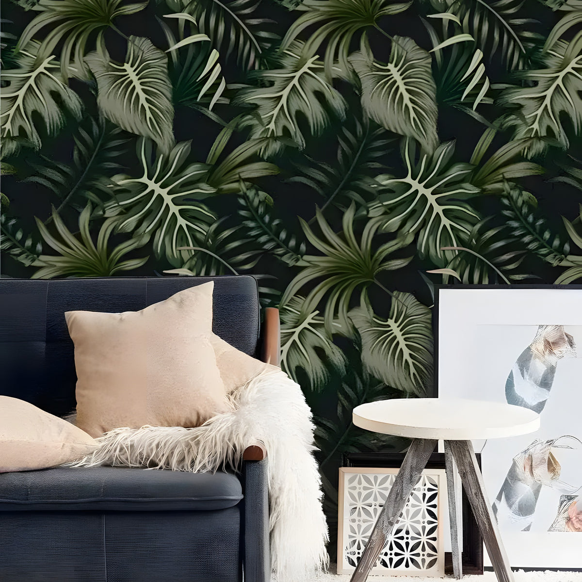 Lush green and black rainforest ferns wallpaper behind navy armchair with tan pillow and fur throw