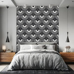 Bedroom with grey bedding and wood nightstands, art deco black cranes wallpaper fan pattern on accent wall strip