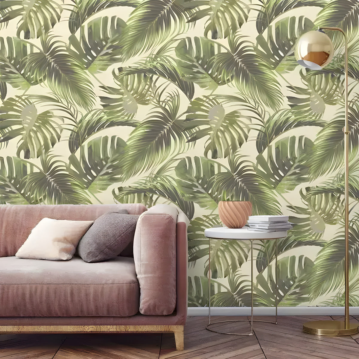 Vintage green monstera wallpaper with overlapping dark and light green tropical palm fronds on cream, blush sofa, gold lamp