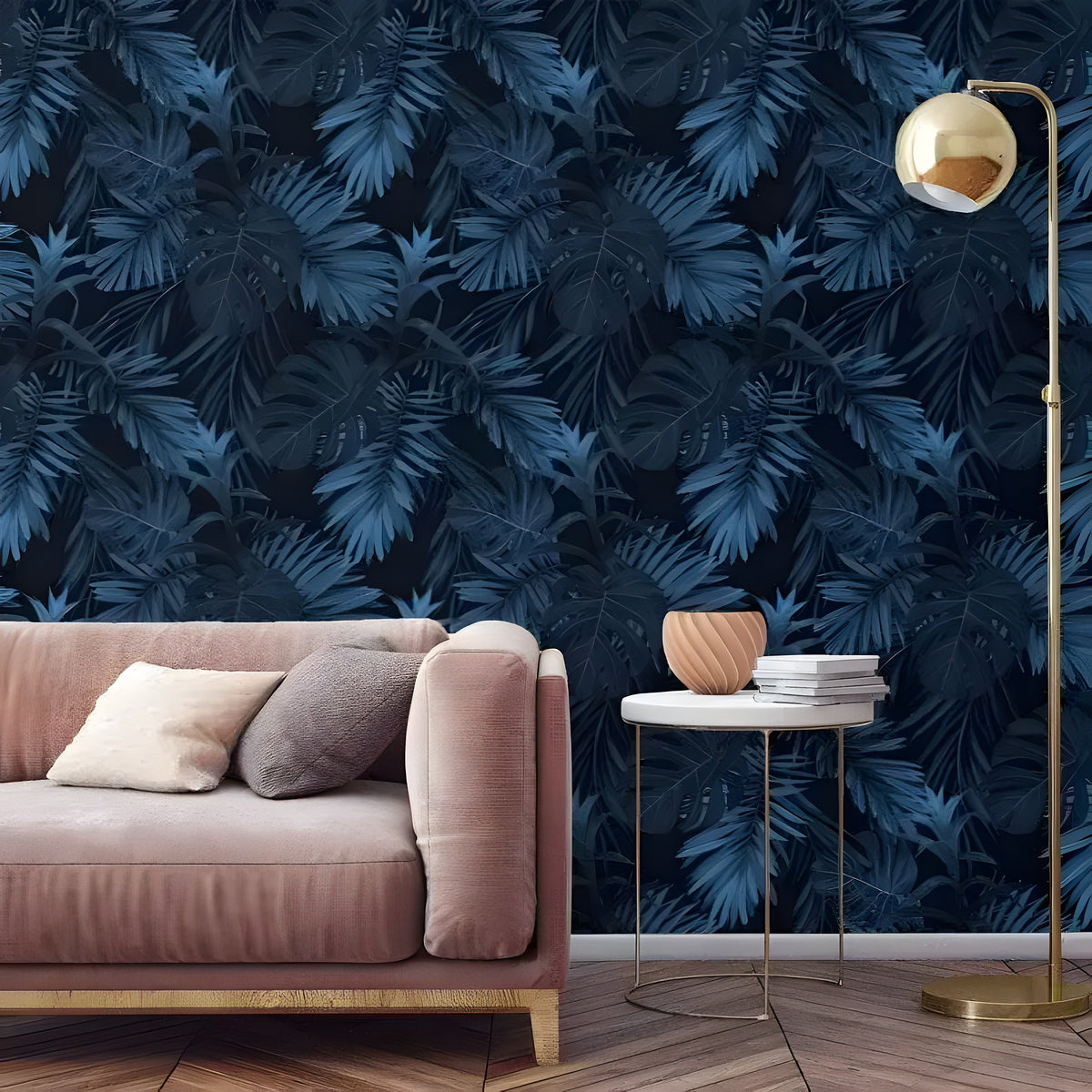 Large dark navy tropical foliage wallpaper in living room with pink velvet sofa and gold arc lamp