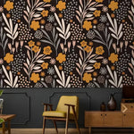 Dark modern drawing yellow floral wallpaper above dark paneling behind mustard retro chair and oak sideboard in vintage living room