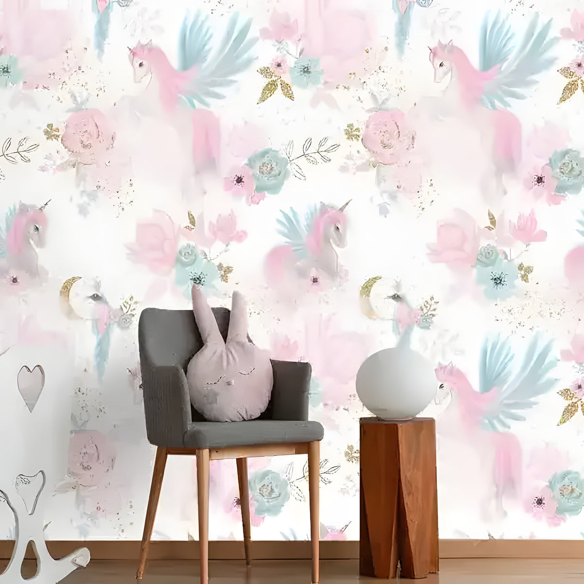 Pastel pink unicorn floral nursery wallpaper in room with gray chair, bunny pillow, white crib