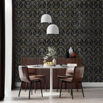 Dining room with white round table, brown leather chairs, wood sideboard; art deco geometric wallpaper with gold oval links on black
