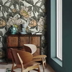 Dramatic oversized floral wallpaper in styled room with rich botanical motif and statement furniture