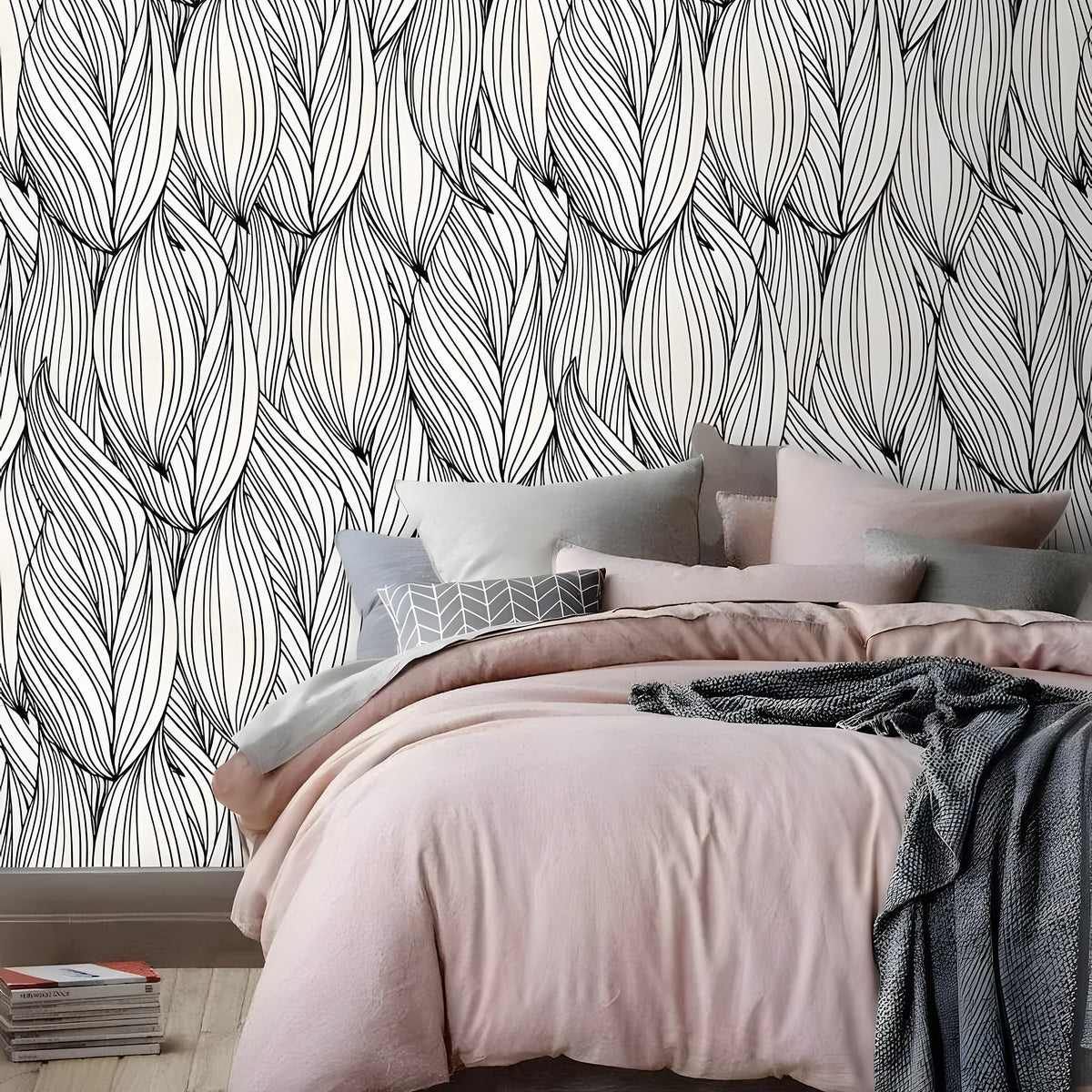 Black and white oversized winter leaves wallpaper in a bedroom with pink bedding, grey throw, and wood floor