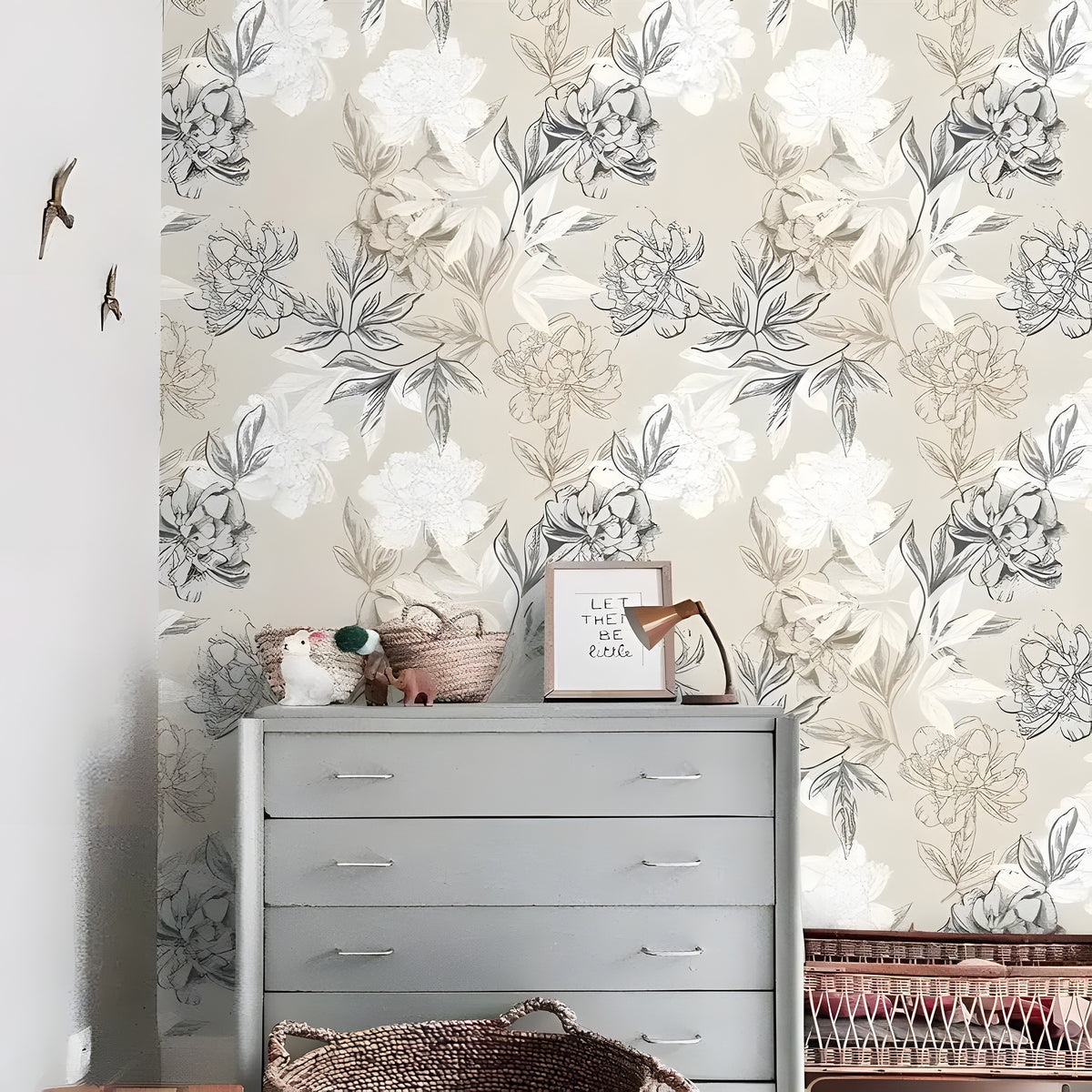 Gray and white floral peony wallpaper in a nursery with a gray dresser, wicker baskets, and bird wall ornaments