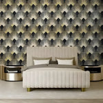 Dark gold art deco fans wallpaper in styled room with velvet armchair and warm lighting