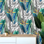 Blue and green tropical banana leaves and flowers wallpaper installed in a room, vibrant aqua and green foliage on walls