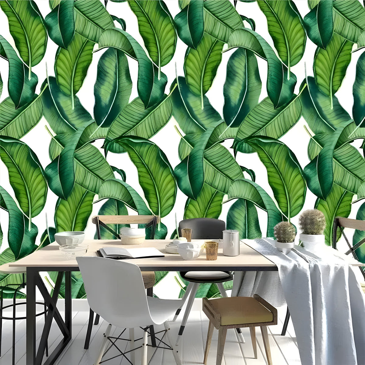 Dining table with white runner and cactus; green and white banana leaves tropical wallpaper with large dark green overlapping leaves