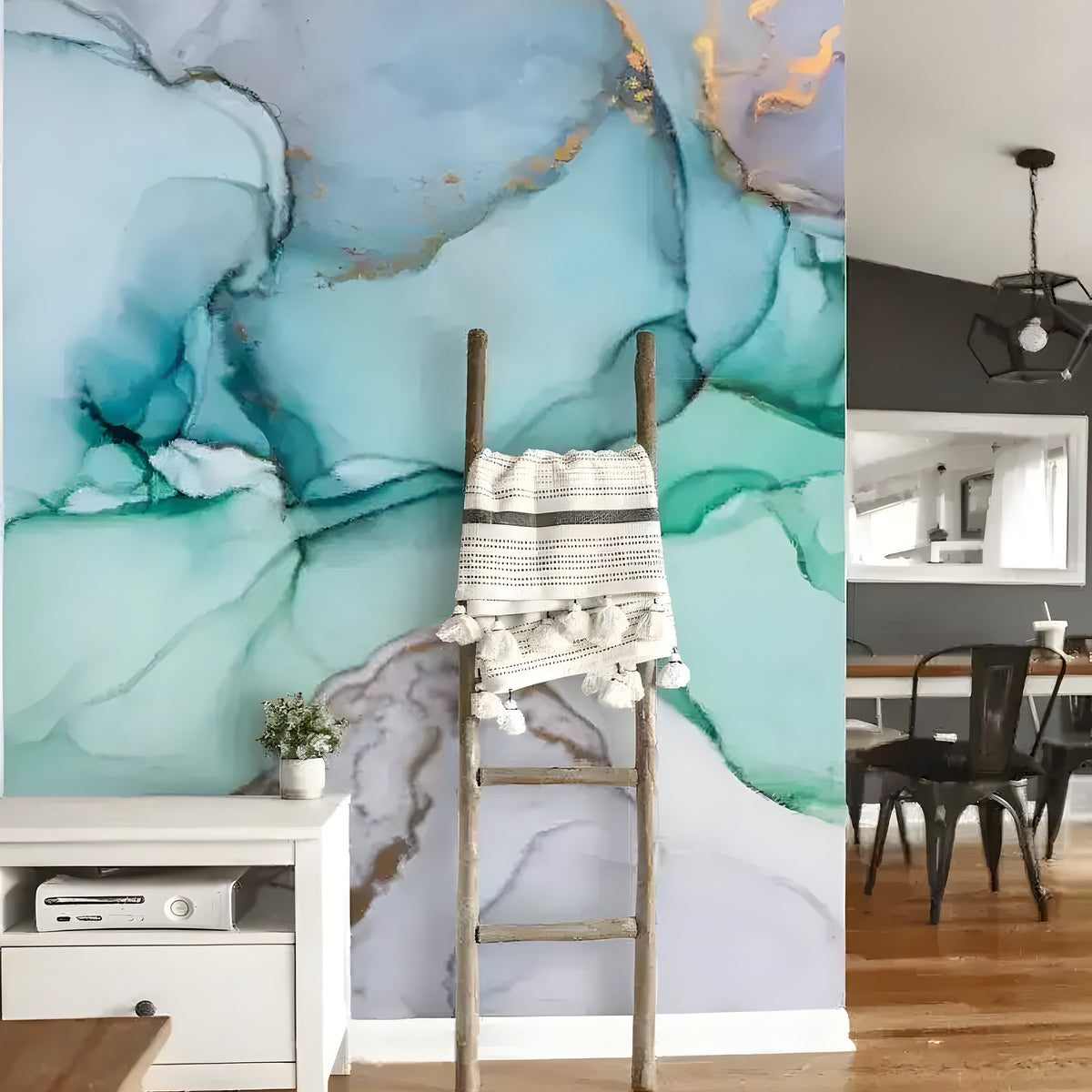 Blue watercolor marble wallpaper in open-plan living space with wooden ladder, woven blanket, and dining area visible