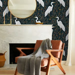 Black and white crane chinoiserie wallpaper in a styled room with natural light and soft furnishings