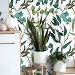 Green Leaves Botanical Watercolor Wallpaper with detailed leaf and berry sprigs on white, Scandi sideboard