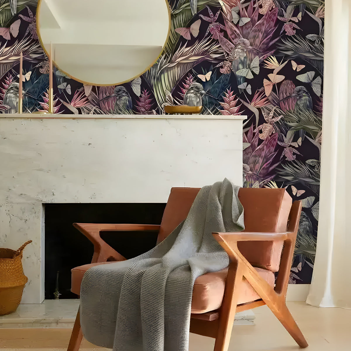 Tropical floral hummingbirds butterflies wallpaper on navy with pink heliconias and parrots as chimney breast behind tan lounge chair