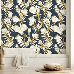 White and navy protea wallpaper with gold stems in a bright room with wicker accents and white built-in bench