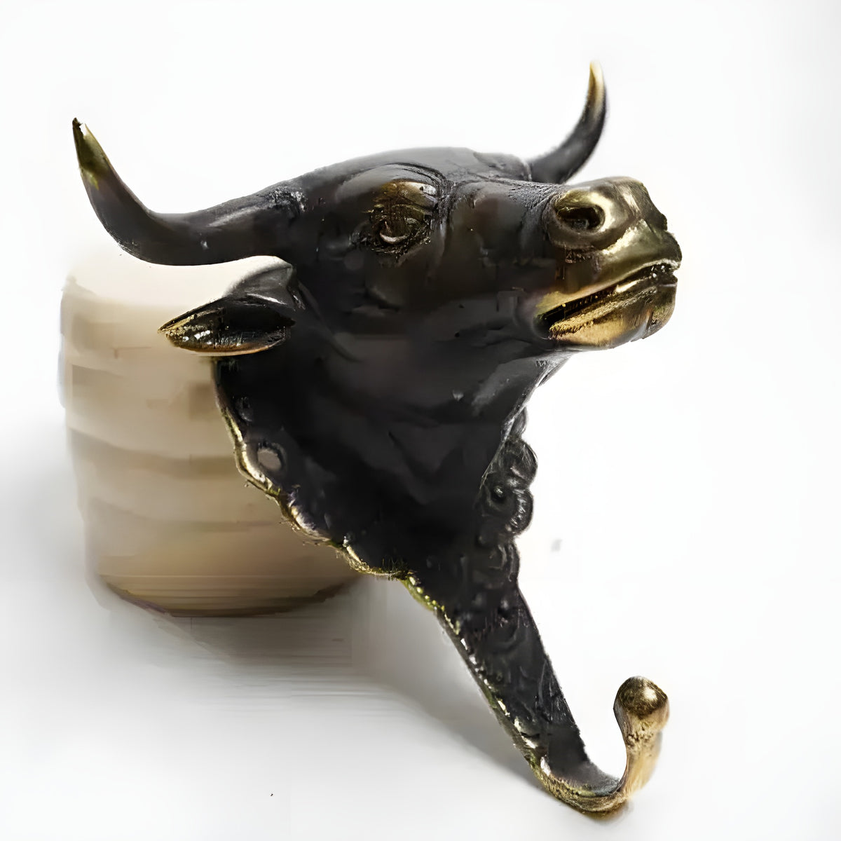 Black and gold buffalo wall hook on ceramic spool, dark bull head with upturned gold-tipped horns and ornate hook