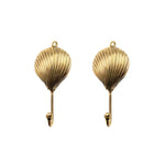Two gold brass shell-shaped wall hooks, front view, ridged scallop shell design with mounting loop and curved hook