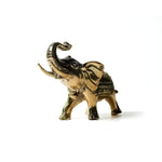 Solid brass royal elephant figurine with raised trunk and decorated blanket, polished gold standing pose, side view