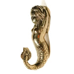 Polished brass mermaid wall hook side profile, flowing wavy hair, scaly tail curling to hook tip