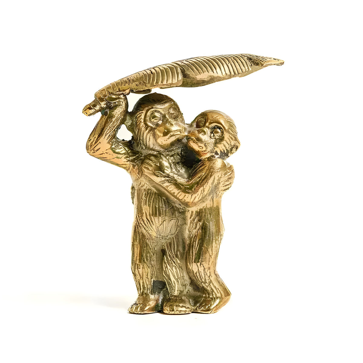 Two monkeys hugging under banana leaf figurine in polished brass, front view on white background