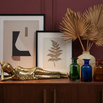 Bronze Reclining Buddha Figurine styled in a room setting