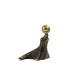 Dark brass dolphin and ball miniature figurine, dolphin reclining on flippers with polished gold ball balanced on nose