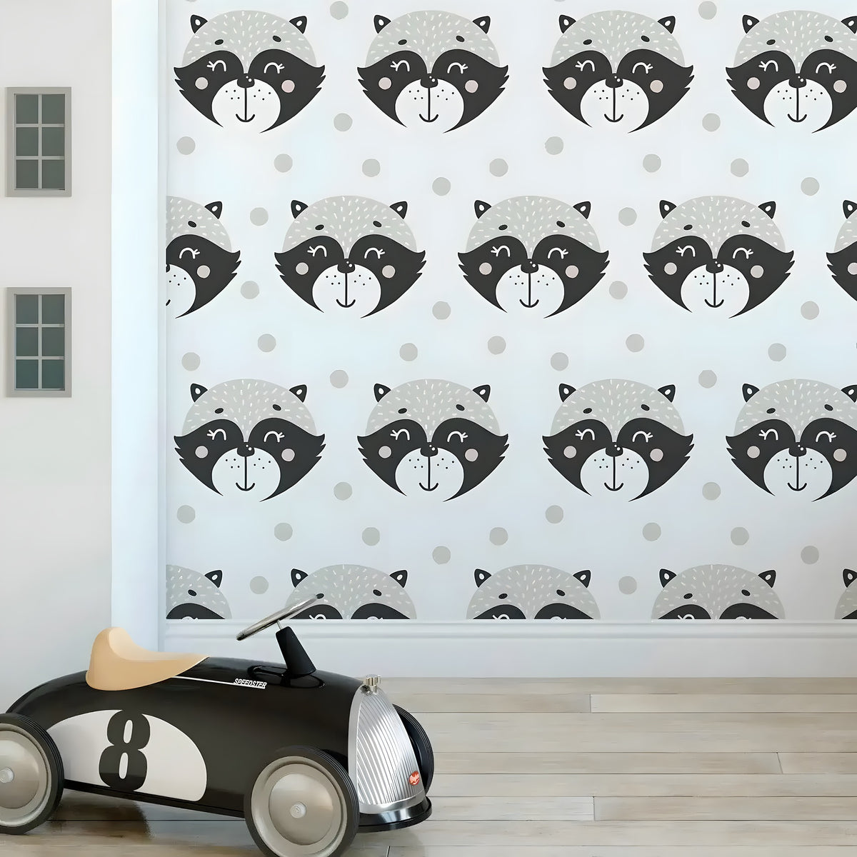 Friendly raccoons kids wallpaper in playroom, cartoon raccoon faces on white with polka dots, toy race car on floor
