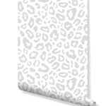 Rolled gray leopard spots wallpaper showing light gray animal print pattern on white, roll view