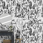 Abstract female line art wallpaper with faces, roses and brushstroke text in a bathroom with dark vanity