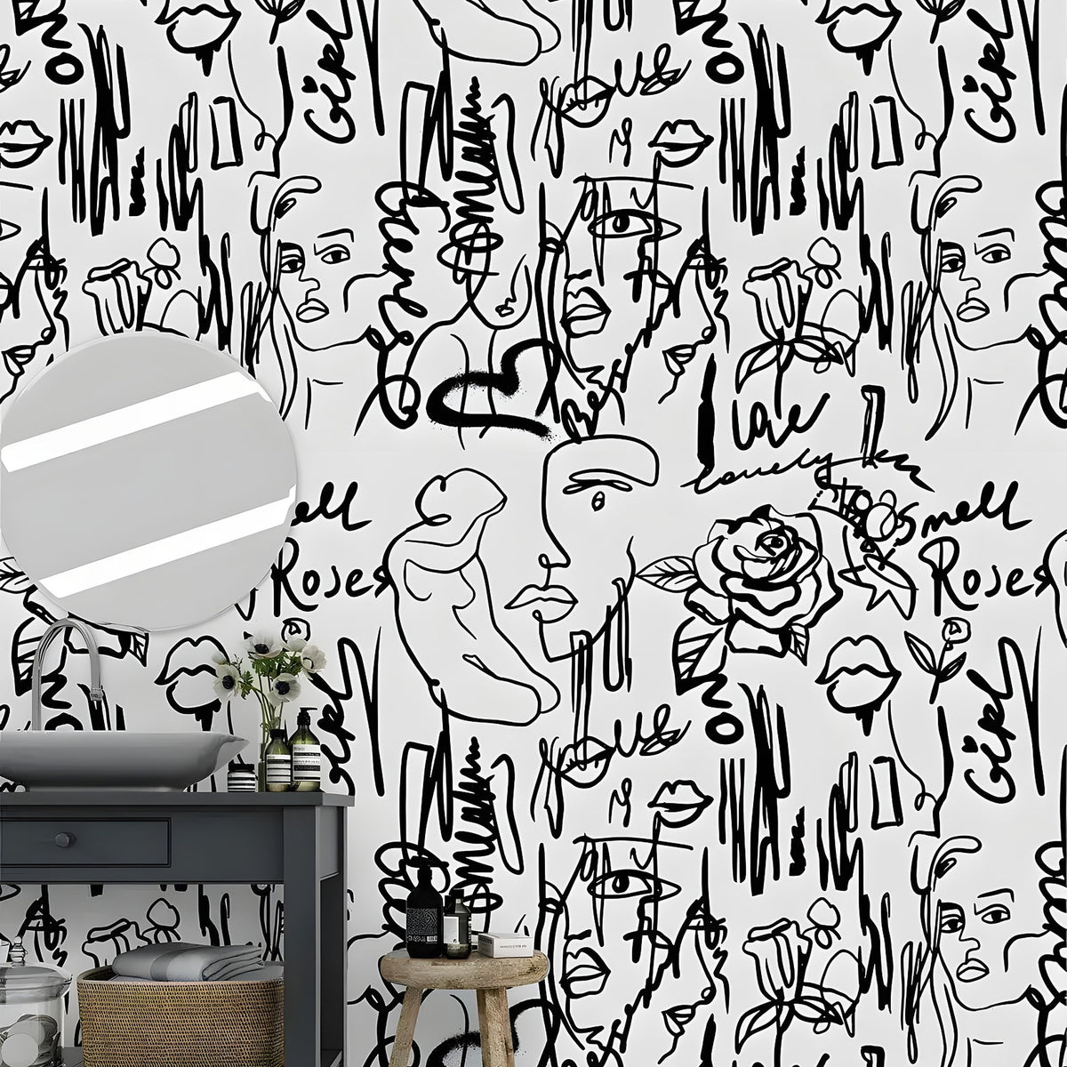 Abstract female line art wallpaper with faces, roses and brushstroke text in a bathroom with dark vanity