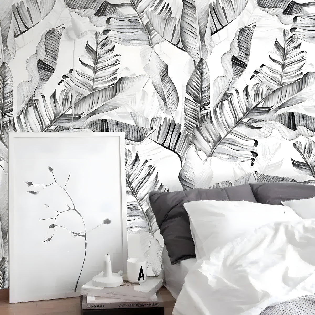 Black and white watercolor tropical palm leaves wallpaper on bedroom headboard wall, overlapping monstera and banana leaves