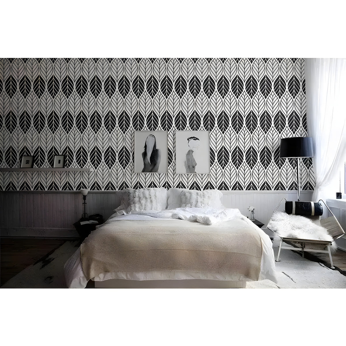 Black and white geometric leaves wallpaper as bedroom headboard wall with framed artwork and white bedding