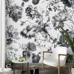 Black and white French Toile floral mural shown in a room behind a white chair and side table