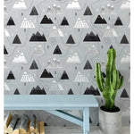 Scandinavian mountains and routes wallpaper on grey background, styled with blue bench and cactus