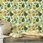 Yellow green avocado kitchen wallpaper in a kitchen with repeating avocado pattern, rustic wood counter below