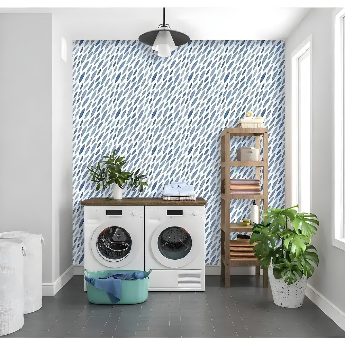 Blue watercolor petals wallpaper in a laundry room with washing machines and bamboo shelving