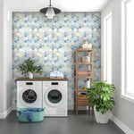 Laundry room with washer and shelving unit against hexagon honeycomb removable wallpaper in blue-green